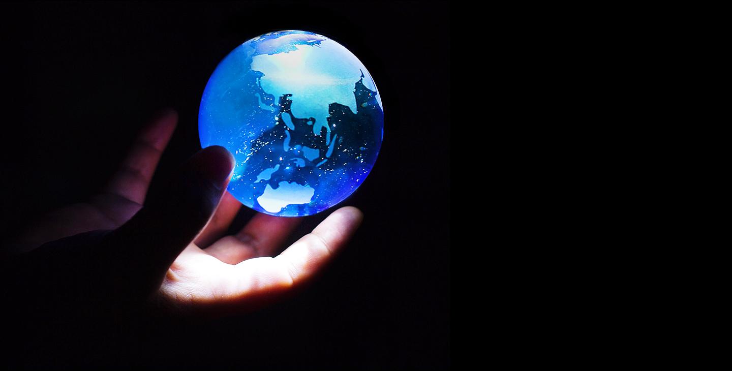 Hand holding globe of the world