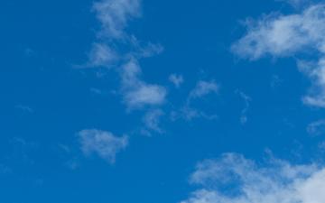 Light-blue sky background with white clouds