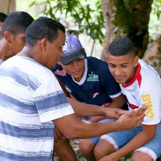 young men connecting over mobile through community wi-fi
