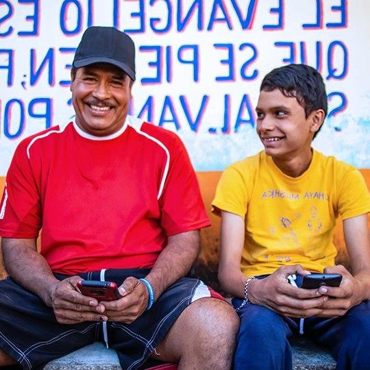 father and son connecting globally on mobile